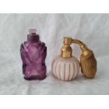 A purple glass scent bottle with stopper and another