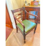 A Regency period mahogany elbow chair with stretcher base