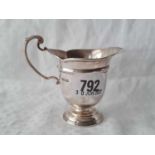 A helmet shaped cream jug with leaf capped handle, 3 1/4" high, Sheffield 1910, 80g