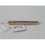 15ct & platinum bar brooch set with a line of natural pearls, length 44mm