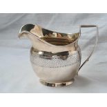 A George III cream jug with bright cut band – 5” wide – London 1807 – 112 g.