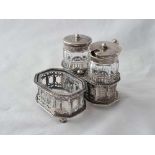 An attractive cruet with three mounted bottle and pierced sides, leaf capped handle, 3” wide,