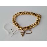 A VINTAGE 18CT (unmarked) CURB LINK BRACELET with pearl set ‘V’ safety chain 21.4g