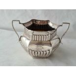 A hexagonal sugar bowl with half fluted body and two handles, 5" wide, Birmingham 1898, 127g