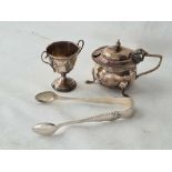 A circular mustard pot, a pair of sugar tongs and a tiny cup