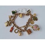 A HEAVY VINTAGE 9CT GOLD CHARM BRACELET WITH 14 ASSORTED CHARMS 45.2g