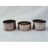 A scroll engraved napkin ring, Birmingham 1911 and two others also plain, 55 g.