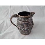 A embossed Indian jug decorated with figures, elephant head handle, 3" high, 92g