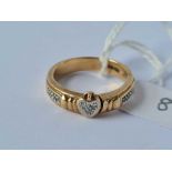 A folding secret message ring with diamond heart and shoulders opening to reveal a message (I love