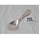 A Millennium caddy spoon, 4" long by RC