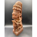 An African carved wood figure, the base signed Akin Fakeye, 17" high