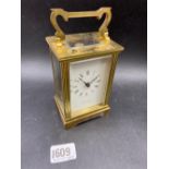 A brass carriage clock from Mappin & Webb with a key, 5” high