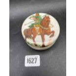 A Chinese circular jar and cover with figure on horseback, 3" diameter