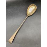 A George III serving spoon with feather edge border and oval bowl, London 1814 by RT, 88g