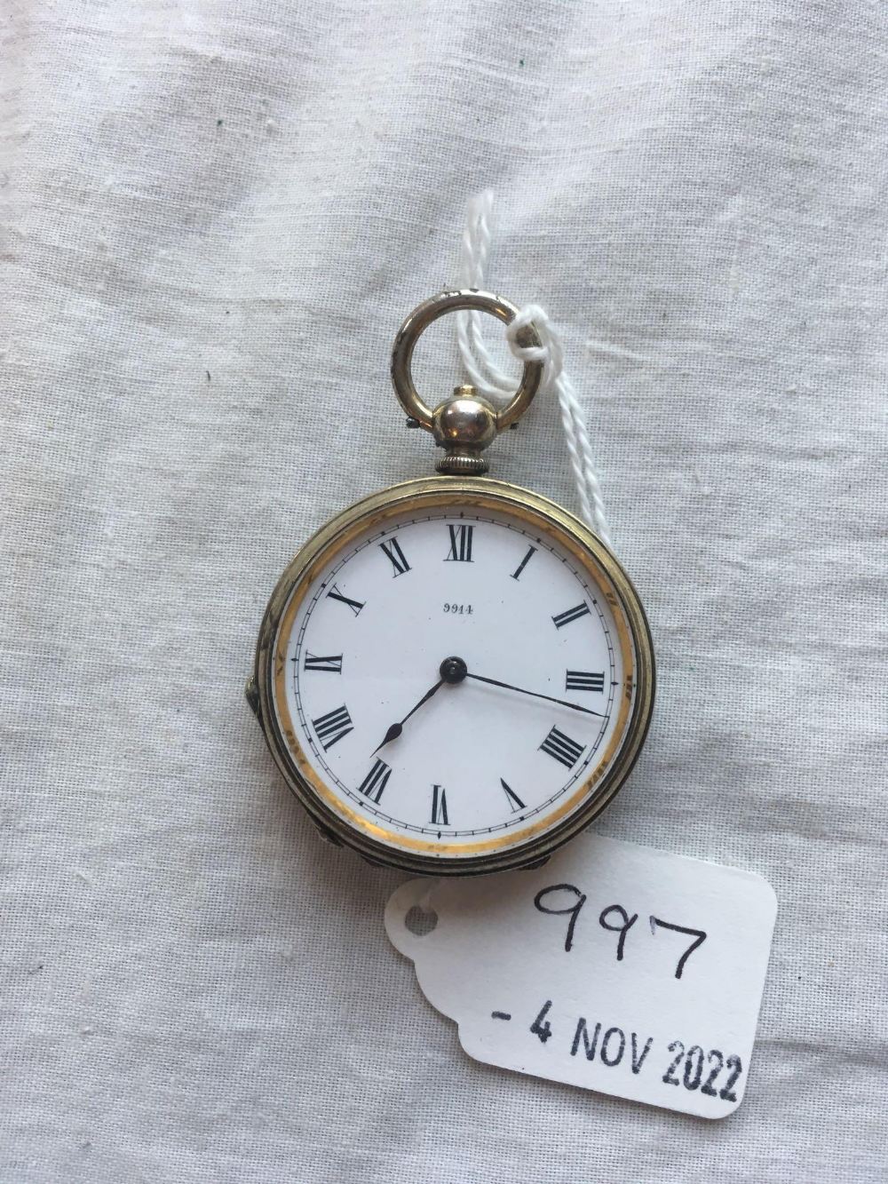 A ladies silver fob watch on silver chain with key W/O