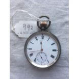 A gents silver pocket watch with gold coloured hands and winder W/O
