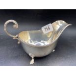 An oval sauce boat with reeded rim, three pad feet, 6" wide, Sheffield 1923 by W&H, 148g