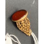 A 19th century high carat gold eastern seal carnelian intaglio of flowers