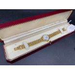 A ladies RAYMOND WEIL wrist watch with date aperture and gilt strap