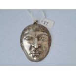 A silver face pendant