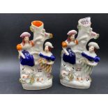 A pair of Staffordshire spill vases with figures 7 inches high