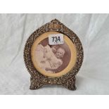 An embossed circular photo frame, easel shaped, 6" high, Birmingham 1899 by SH