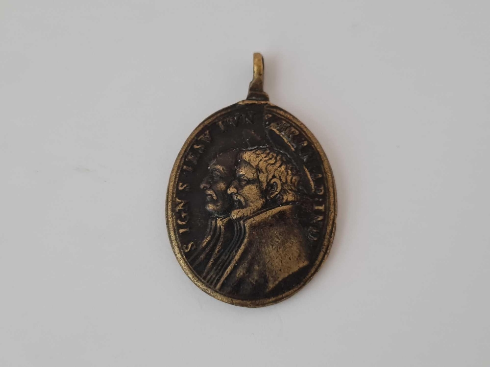 Antique Georgian oval pendant in brass depicting two male figures on one side with a latin - Image 2 of 2