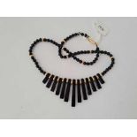 A Cleopatra style onyx and gold bead necklet with gold barrel clasp