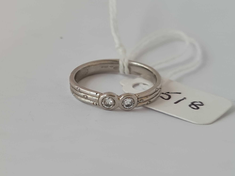 Platinum hallmarked 2/s diamond set ring with decorated band, size L