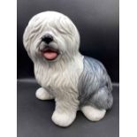 A Italian porcelain figure of a seated dog 12 inches high