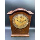 A inlaid mahogany mantel clock with circular dial 11 inches high