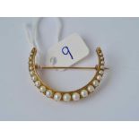 A Victorian pearl set crescent brooch 15ct gold 5.8 gms