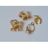 Four gold novelty charms of a dog cat horse shoe and ring 9ct 2.7 gms