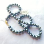 A matched gray pearl necklace with 9ct clasp