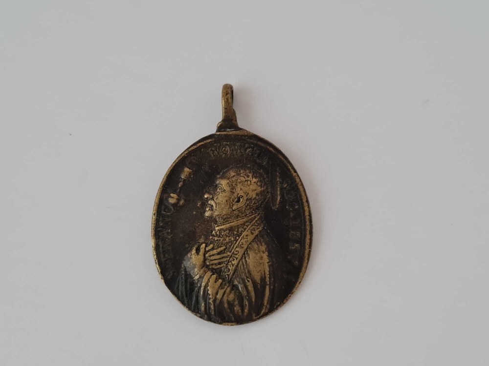 Antique Georgian oval pendant in brass depicting two male figures on one side with a latin