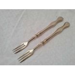 A pair of three prong Victorian silver mounted pickle forks, Sheffield 1885 by HW