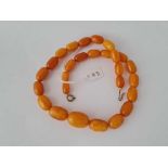 A STRING OF AMBER BEADS 42 GMS