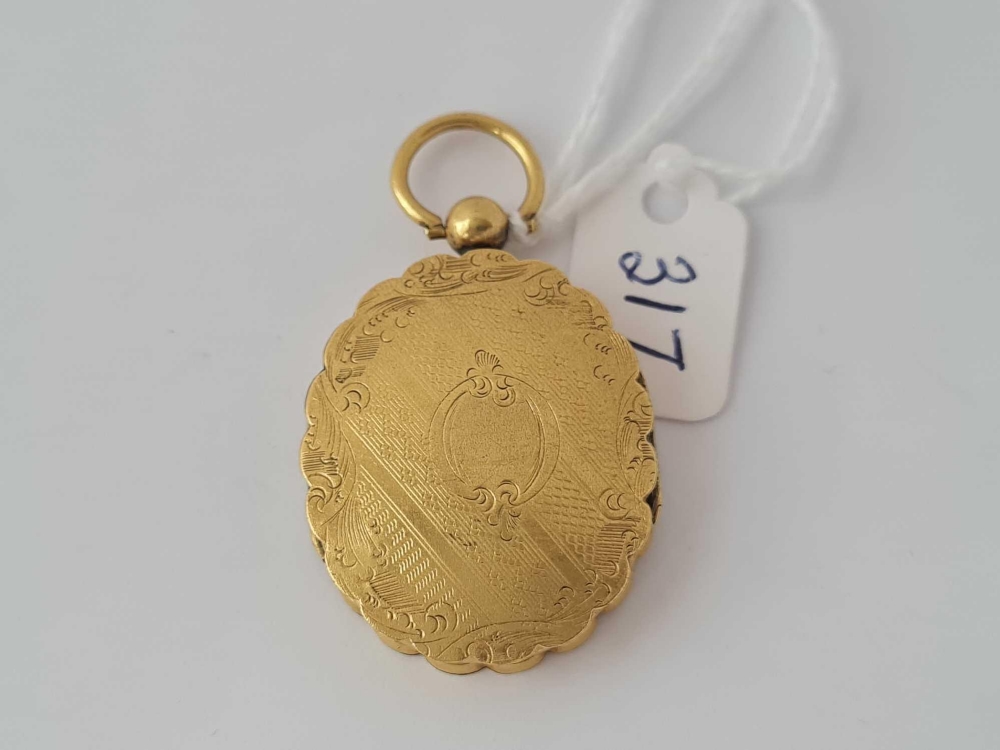 A mid Victorian double opening yellow metal locket with original portrait inside