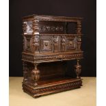 A 17th Century Flemish Carved Oak Three Tier Buffet with central cupboard.