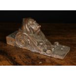 A 17th Century Oak Ornamental Furniture Corbel carved in relief with a protuberant head with