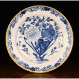 An Early 19th Century Delft Blue & White Plate decorated with a bouquet of flowers to the centre