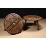 A Pair of Low Rustic Tables composed from solid antique cart wheels with studded iron rims and