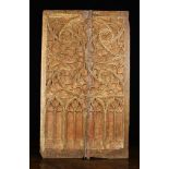 A 16th Century Painted Oak Twin Plank Panel elaborately carved with Gothic tracery displayed