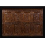A Section of 17th Century Carved Oak Panelling configured in two rows of four arcaded panels.