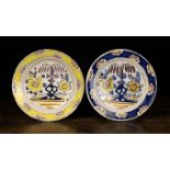 Two Late 18th/Early 19th Century Delft Polychrome Chargers painted in blue, yellow, manganese,