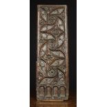 A Fine 15th Century French Carved Chestnut Panel enriched with ball flowers and quatrefoils woven