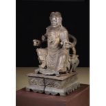 An Antique Oriental Wood Carving of a Dignitary sat upon a throne chair raised on a square plinth,