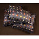 Three Woven Cushions with Jockey Colours on a Navy Blue Ground Fabric,