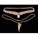 Two Victorian Bone Necklaces: One with a string of small bone beads hung with a carved figural