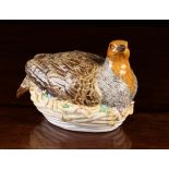 A Fine Meissen Porcelain Partridge depicted on a nest tufted with sprigs of wheat and flowers.